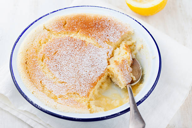 istock Lemon pudding cake with fresh lemons on white wooden background. 537316844