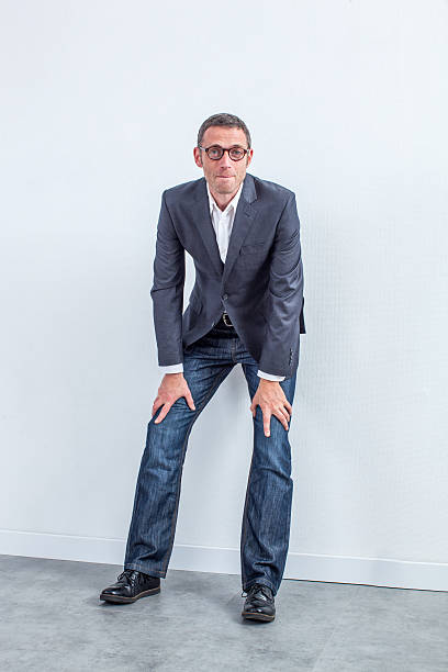 istock handsome middle aged businessman leaning on the office wall 537317632