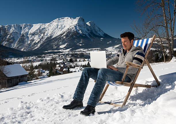 istock Man working with Laptop out in the Snow 537318077
