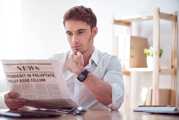 istock Brutal handsome man reading newspaper 537318628