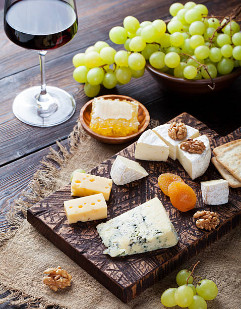 istock Red wine in glass with cheese, honey, nuts and grape 537318696