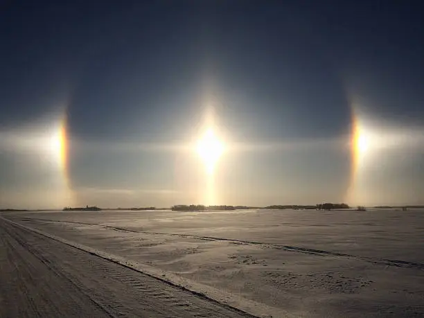 iPhone image of Sundogs over a winter landscape.