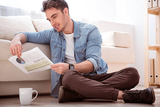 istock Pleasant smiling  man sitting on the floor 537319306