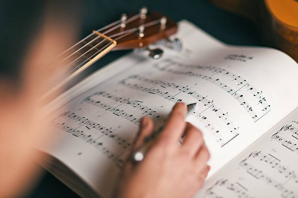 woman studying a musical score woman studying a musical score with shallow depth of field sheet music photos stock pictures, royalty-free photos & images