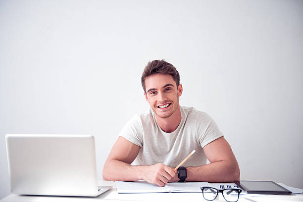 istock Cheerful smiling  man sitting at the table 537321010