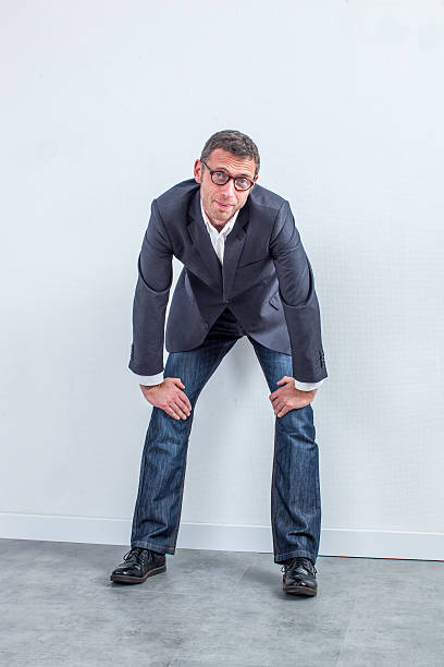 istock thinking businessman standing over an office wall for corporate portrait 537322466