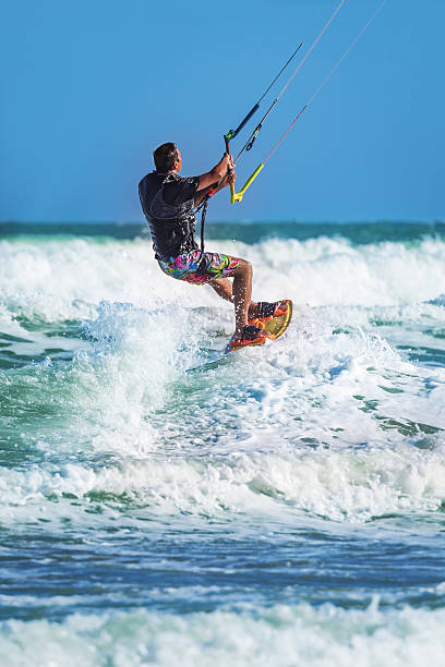 istock Athletic man riding on kite surf board at sea waves 537323424