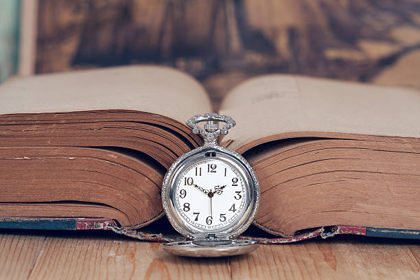 istock Vintage pocket watch on old books. 537330604