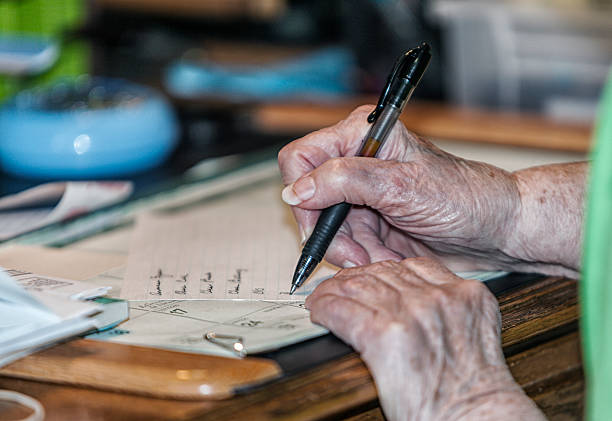 istock Elderly Woman Writing Reminder List 537330850