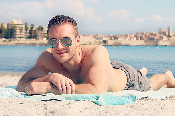 istock Handsome male lying on the sand 537333102