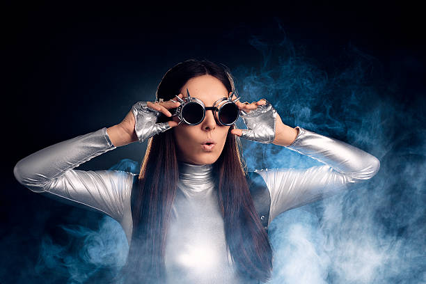 Surprised Woman in Silver Costume and Steampunk Glasses Portrait of a sci-fi retro futuristic robotic girl  steampunk fashion stock pictures, royalty-free photos & images