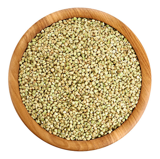 istock Wooden bowl with green buckwheat isolated on white background. 537335564