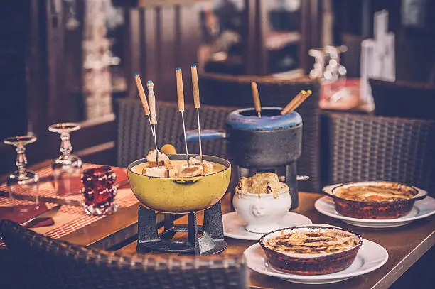 Parisian street cafe with an earthenware pot (caquelon) for fondue 
