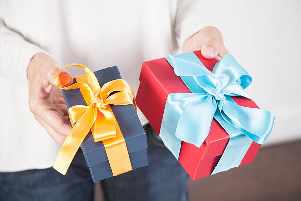 istock woman hands with two gifts 537340694
