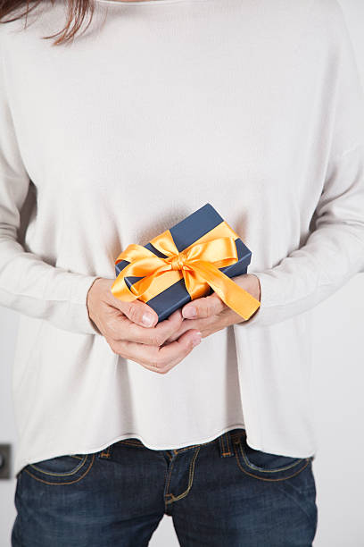 istock woman holding blue gift 537340958