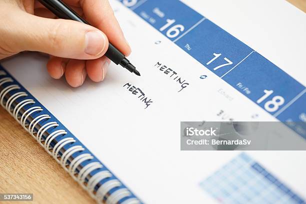 Closeup Of Hand Writing Events On Calendar Stock Photo - Download Image Now - Adult, Animal Mane, Annual Event