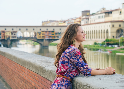 Portrait of pensive woman on embankment near Ponte Vecchio