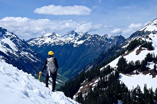istock Man Alpinist Standing on Mountain Top. 537345074