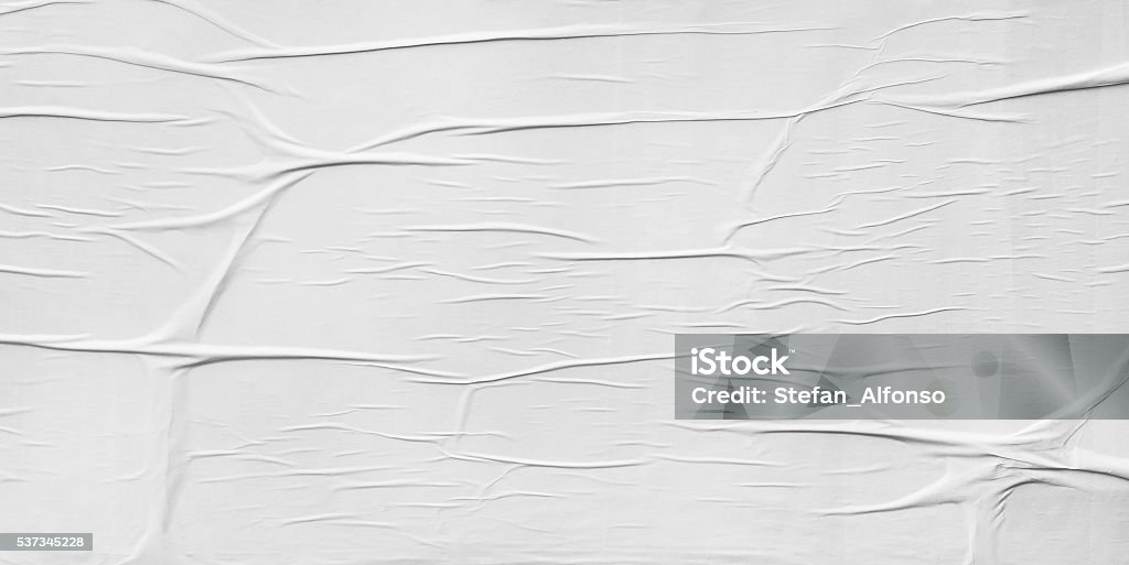 Wrinkled paper glued on wall texture - Royaltyfri Skrynkligt papper Bildbanksbilder