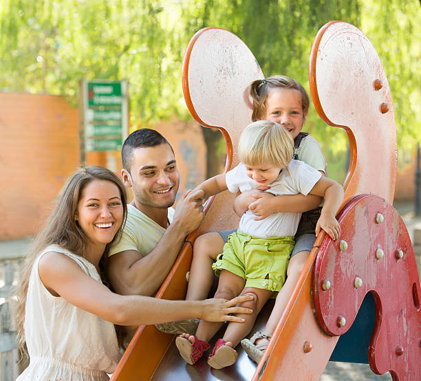 istock Family playing at children's slide 537346235