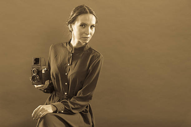istock Woman taking picture with old camera 537346646