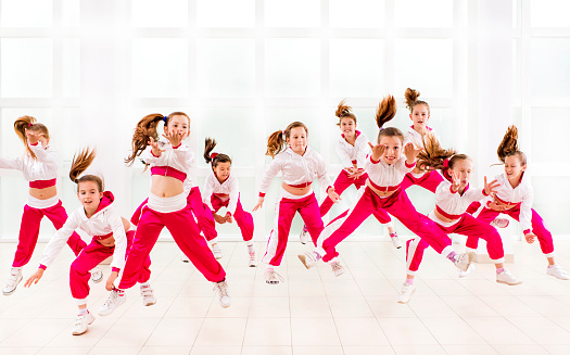 Large group of little dancers in a dance move.   