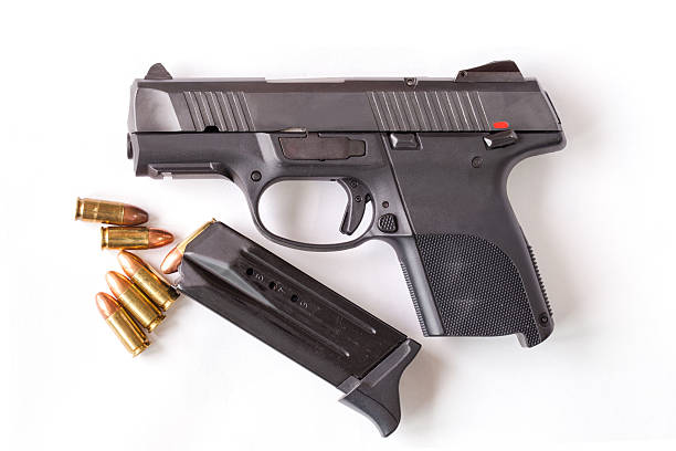 istock Black gun and 9mm bullets isolated a white background. 537346897