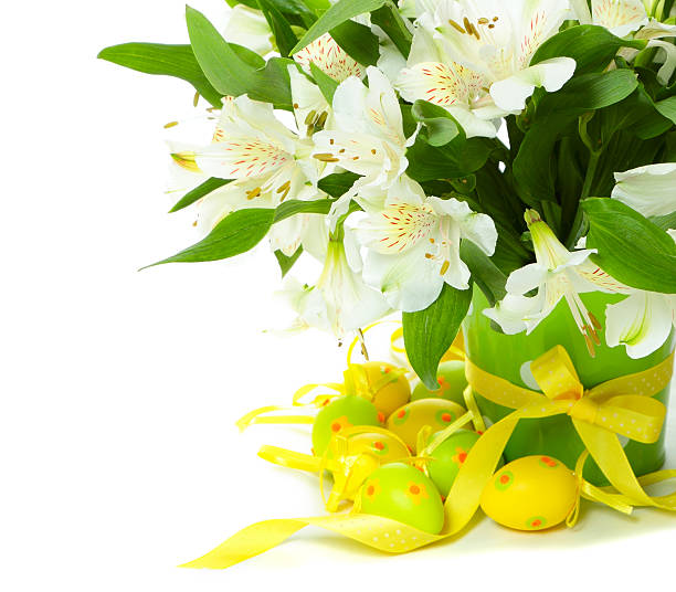 Bouquet of alstroemeria flowers with Easter eggs on white background