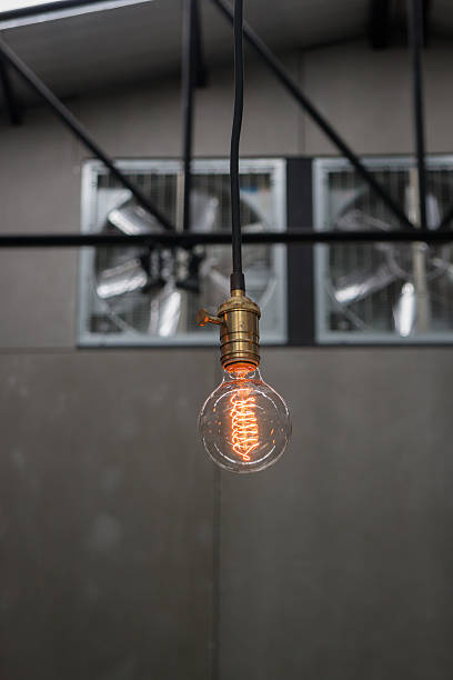 istock Vintage hanging light bulb over gray room 537347550