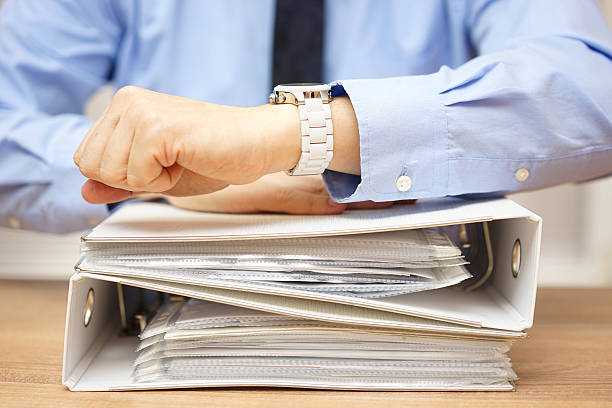 istock businessman with stack of documentation on the desk 537348262