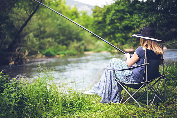 istock woman fishing in river 537348346