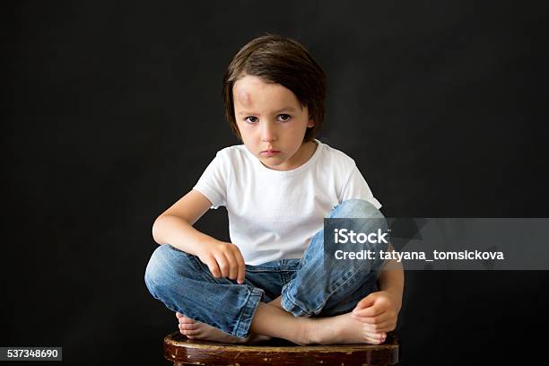 Little Sad Boy With Big Bump On Head From Fall Stock Photo - Download Image Now - Bumpy, Child, Black Color