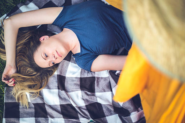 istock Woman smiling and lying on a tent 537348966