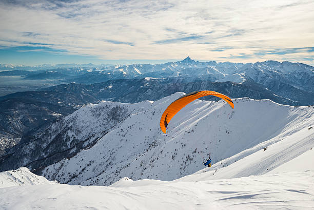 Paraglider flying over the Alps