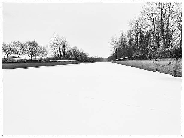 The Erie Canal, frozen and covered with snow, in the winter, from inside the canal bed.
