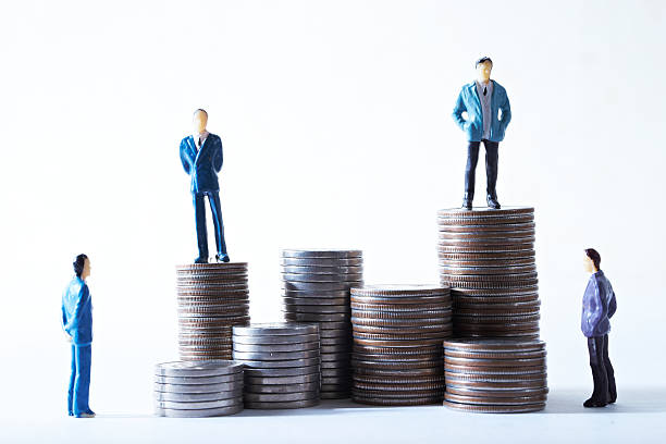 istock Miniature men on pile of coins 537351776