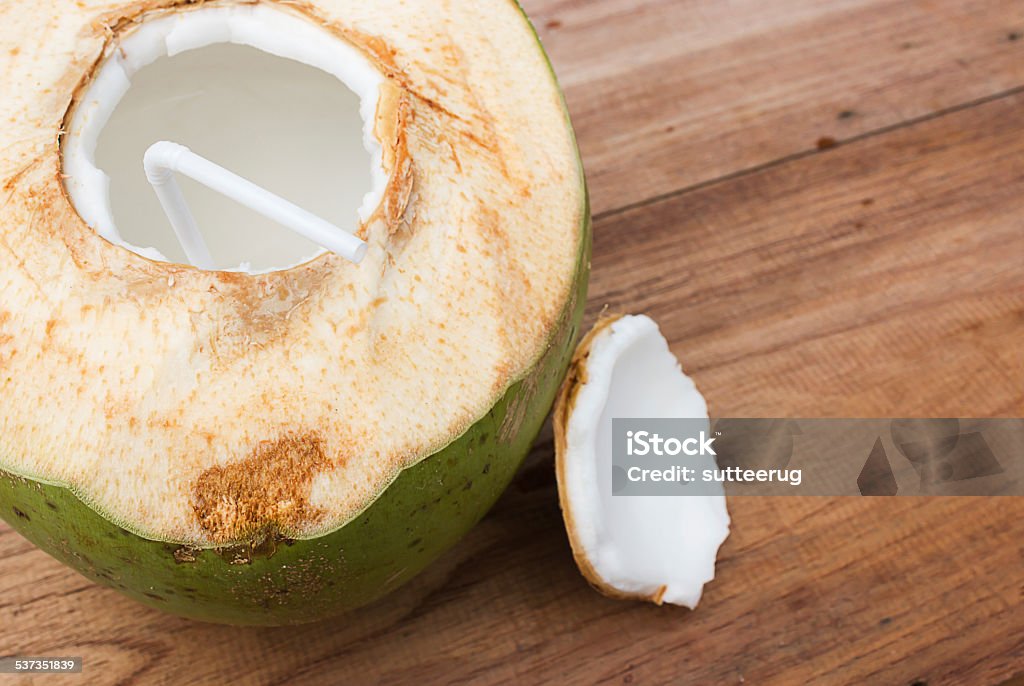 Coconut and juice. Coconut and juice on wood background. Healthy drink. 2015 Stock Photo