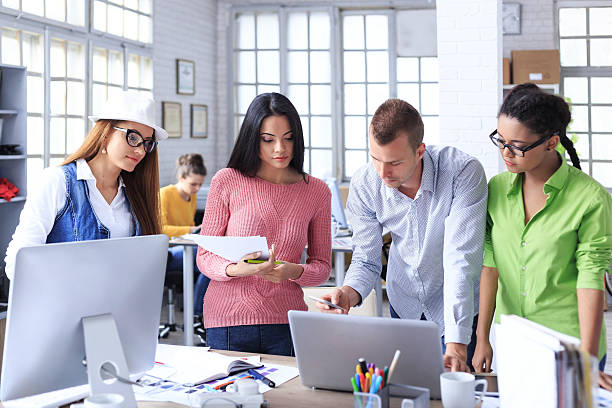 istock Group of young people discussing ideas at office. 537353658