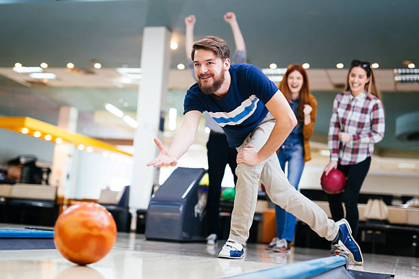 freunde spaß haben und bowling - bowling holding bowling ball hobbies stock-fotos und bilder