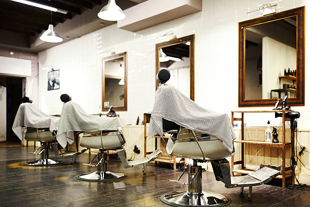 Empty barbershop Empty barbershop with arm-chairs, barber equipment and mirrors on walls salon mirror stock pictures, royalty-free photos & images