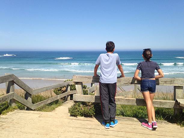 Siblings enjoying the view of the coastline