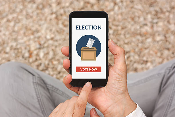 istock Hands holding smart phone with online voting concept on screen 537356146