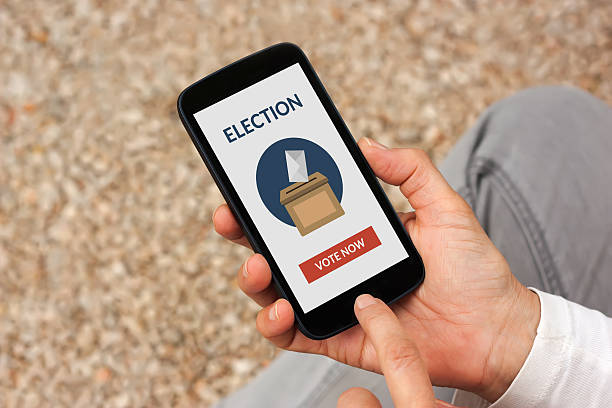 istock Hands holding smart phone with online voting concept on screen 537356226