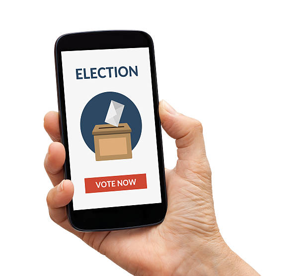 istock Hand holding smart phone with online voting concept on screen 537356370