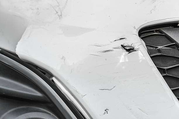 istock Dented wound and scratches on a damaged white car 537357702