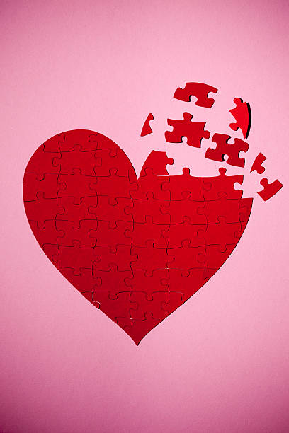 Polyamory puzzle Heart created with puzzle pieces with three pieces missing. menage trois stock pictures, royalty-free photos & images