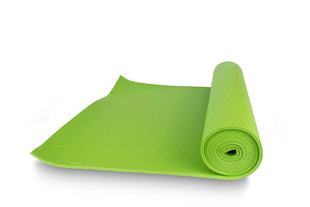 istock Close-up green yoga mat for exercise isolated on white background 537358110