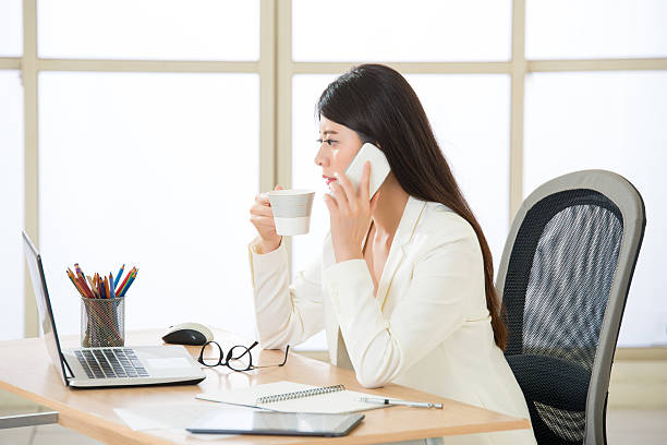 istock Asian businesswomen using smart phone and looking at Computer Screen 537358326