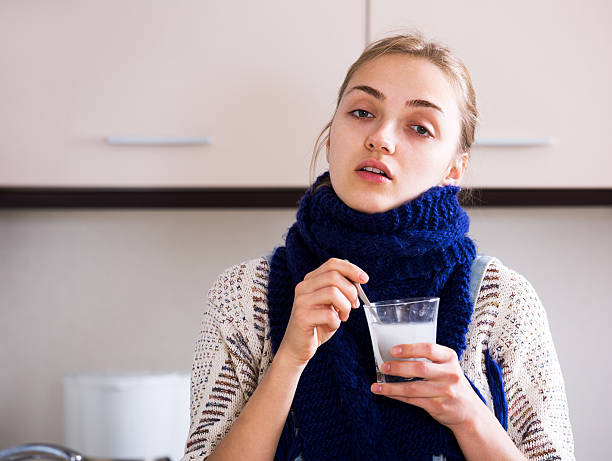 istock Girl with quinsy taking medicine 537358672