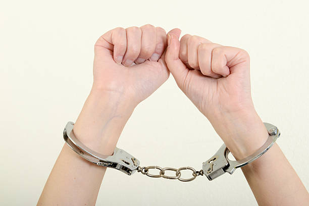 istock Hands of a woman with handcuffs 537358836